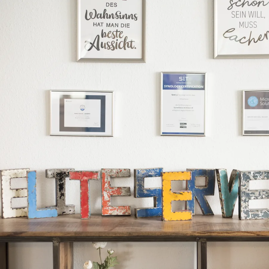 Metallbuchstaben eliteSERVE und Zertifikate im Empfang